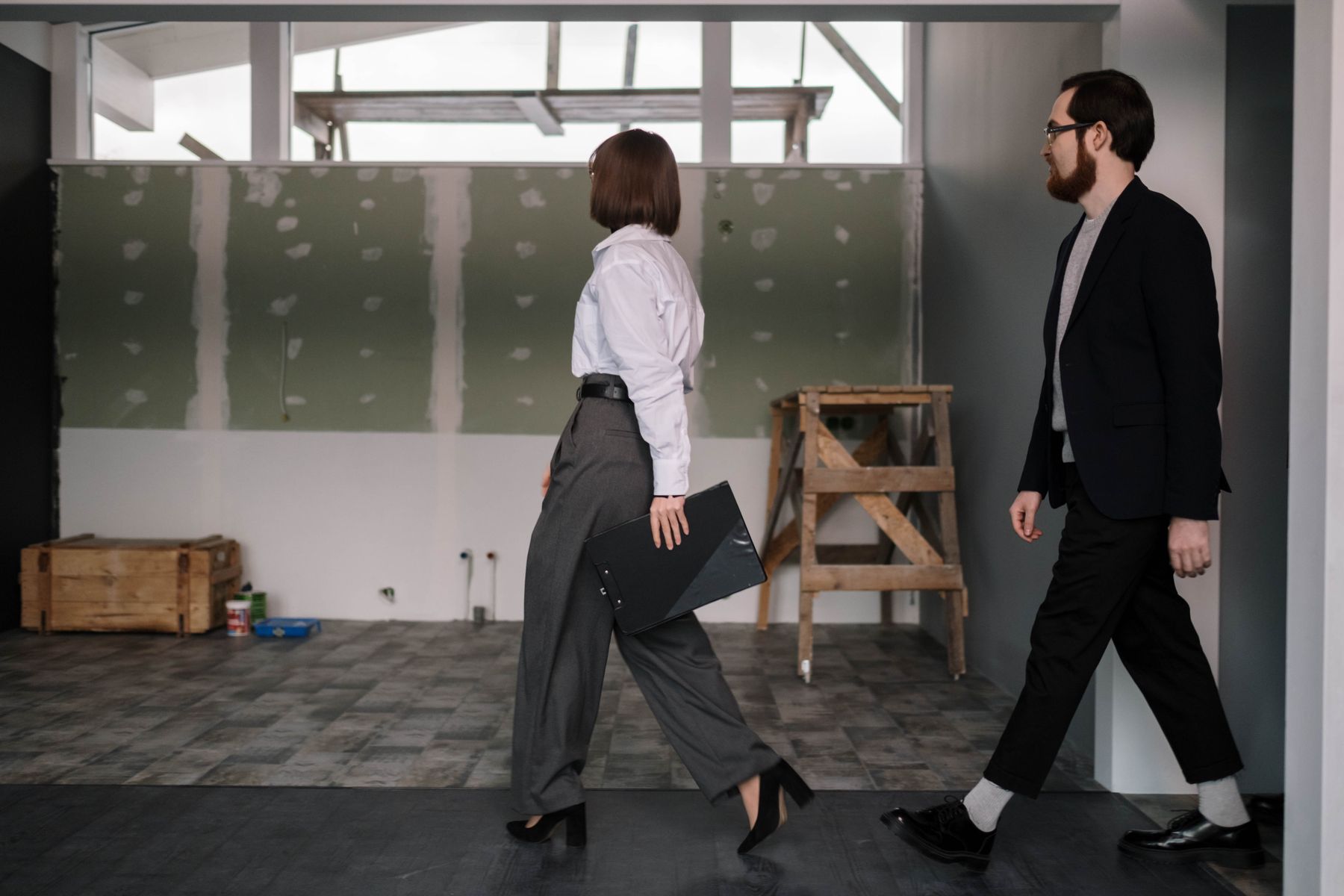 Commercial clients walking through an interior renovation