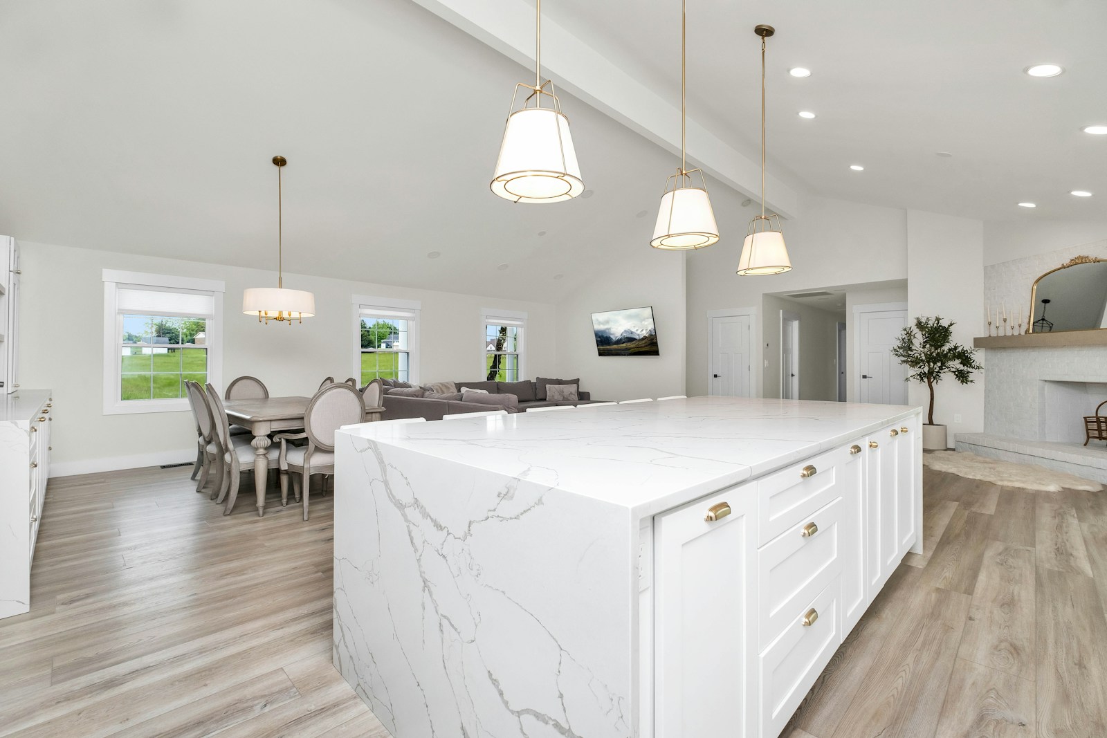 Bright renovated kitchen with a large marble waterfall island